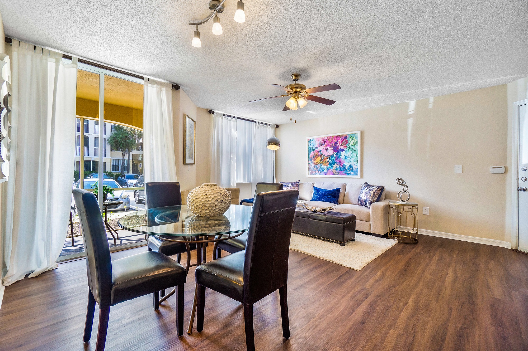 A living room with a glass table and chairs.